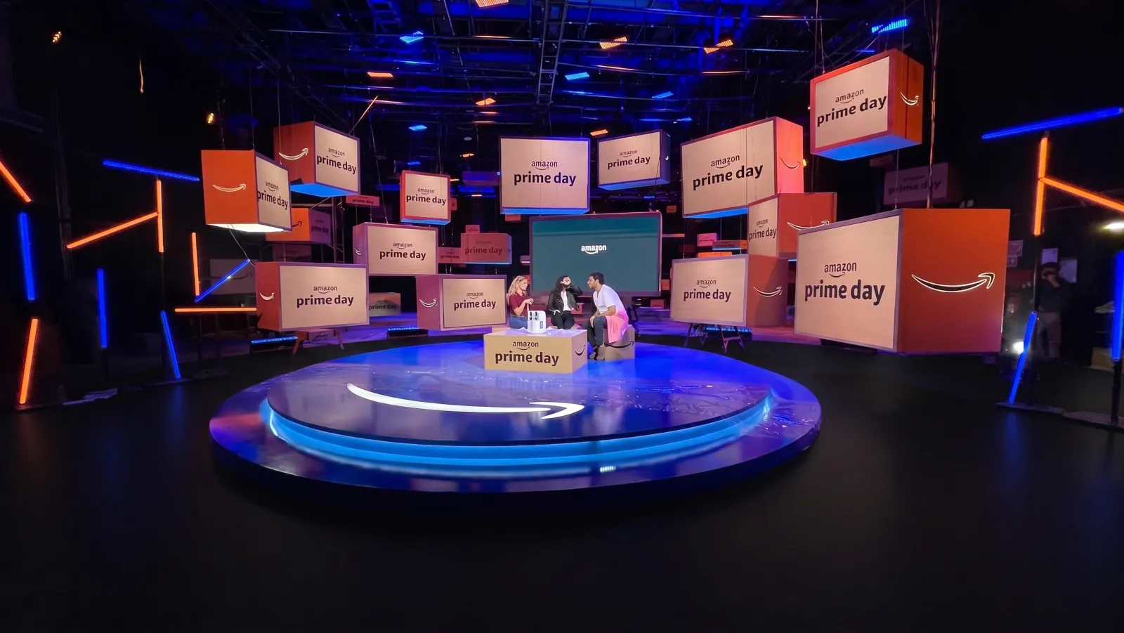 PRIME — The set live: the hosts on the stage, among the boxes
