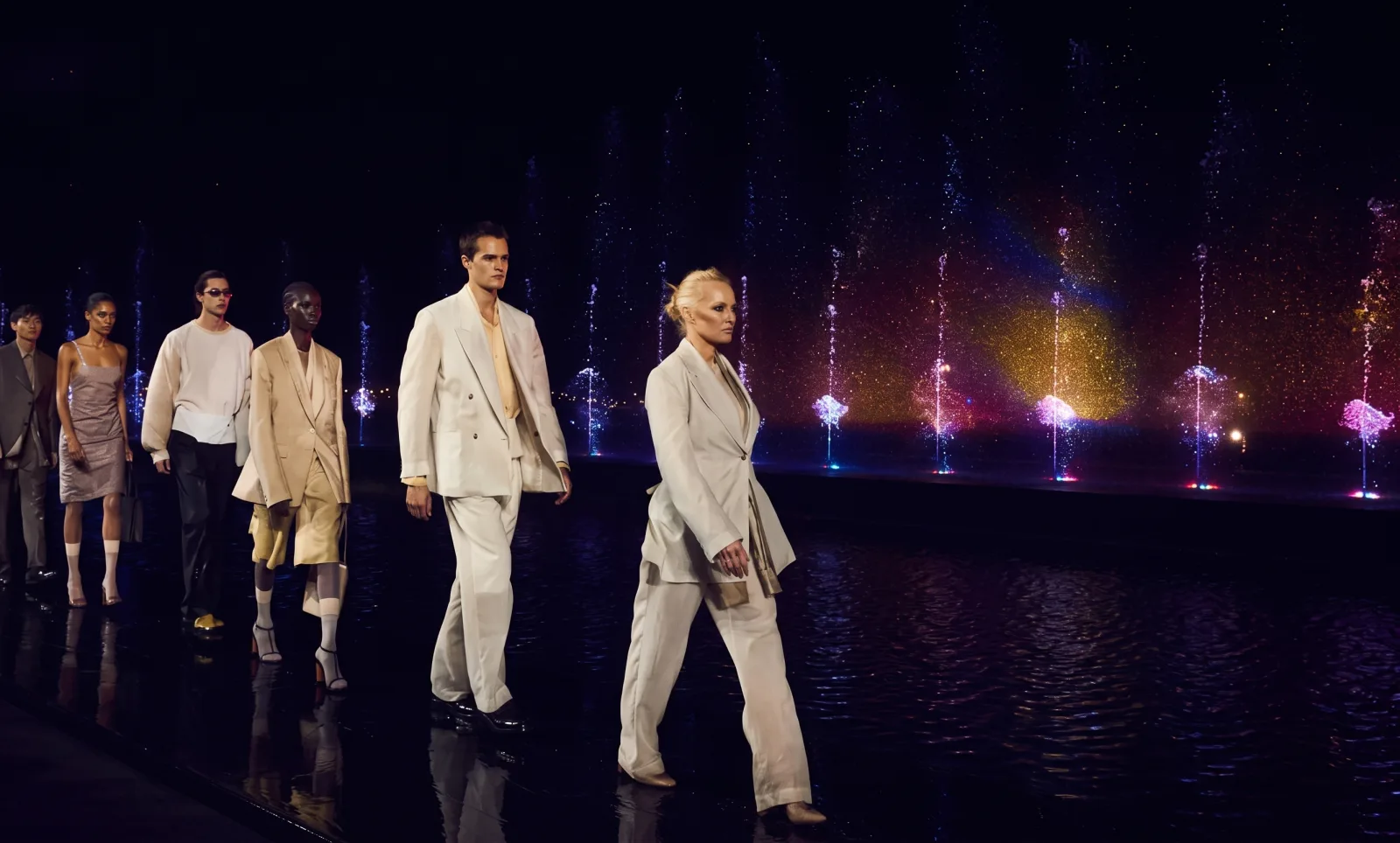 BOSS — The finale, in line, the fountains lit behind