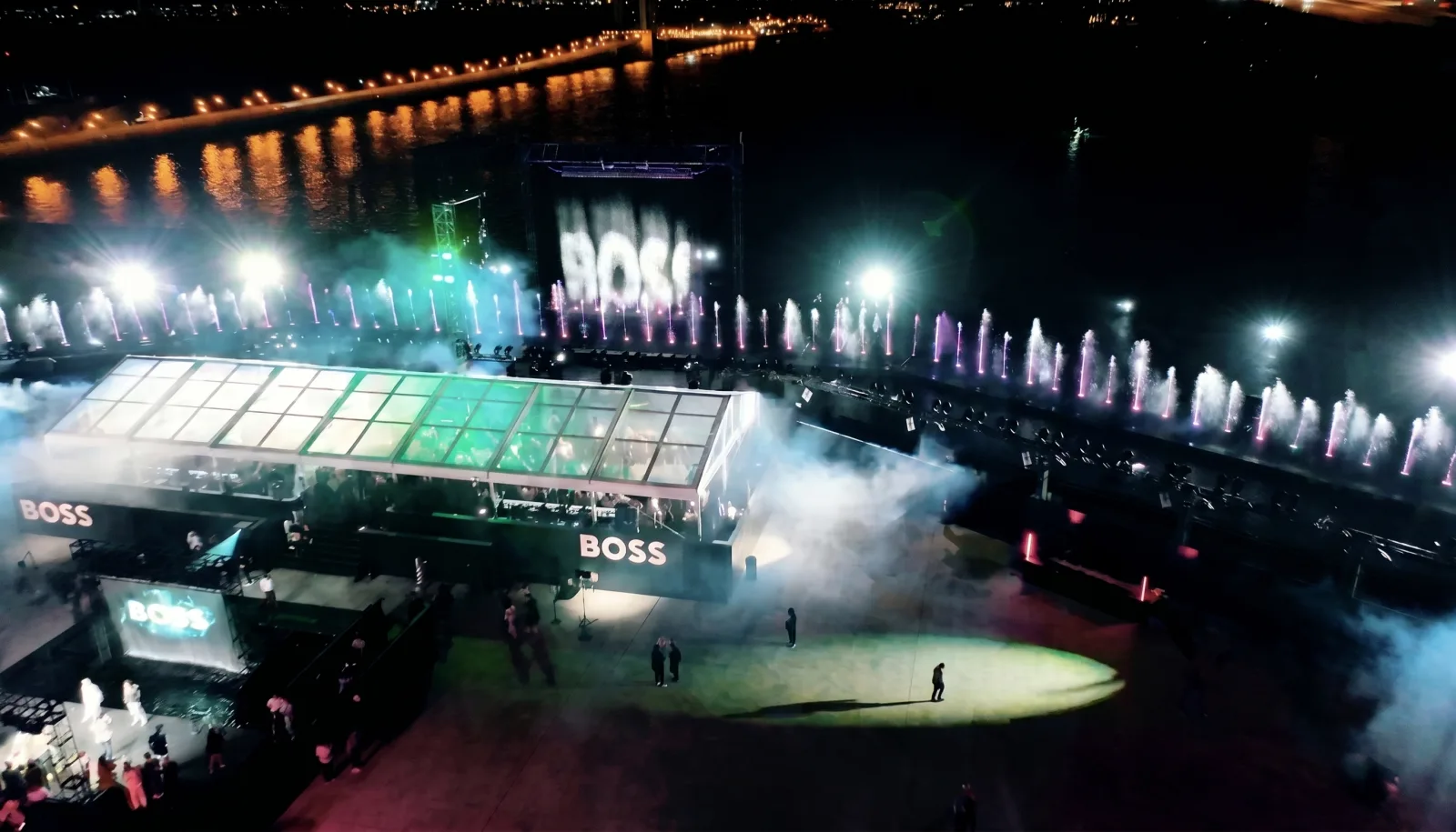 BOSS — The full plaza from above, the city behind