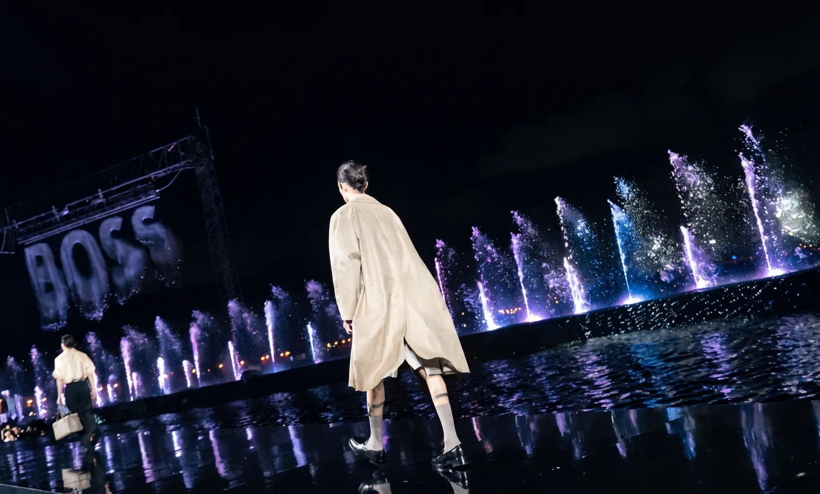 BOSS — A look from the collection, from behind, heading to the fountains