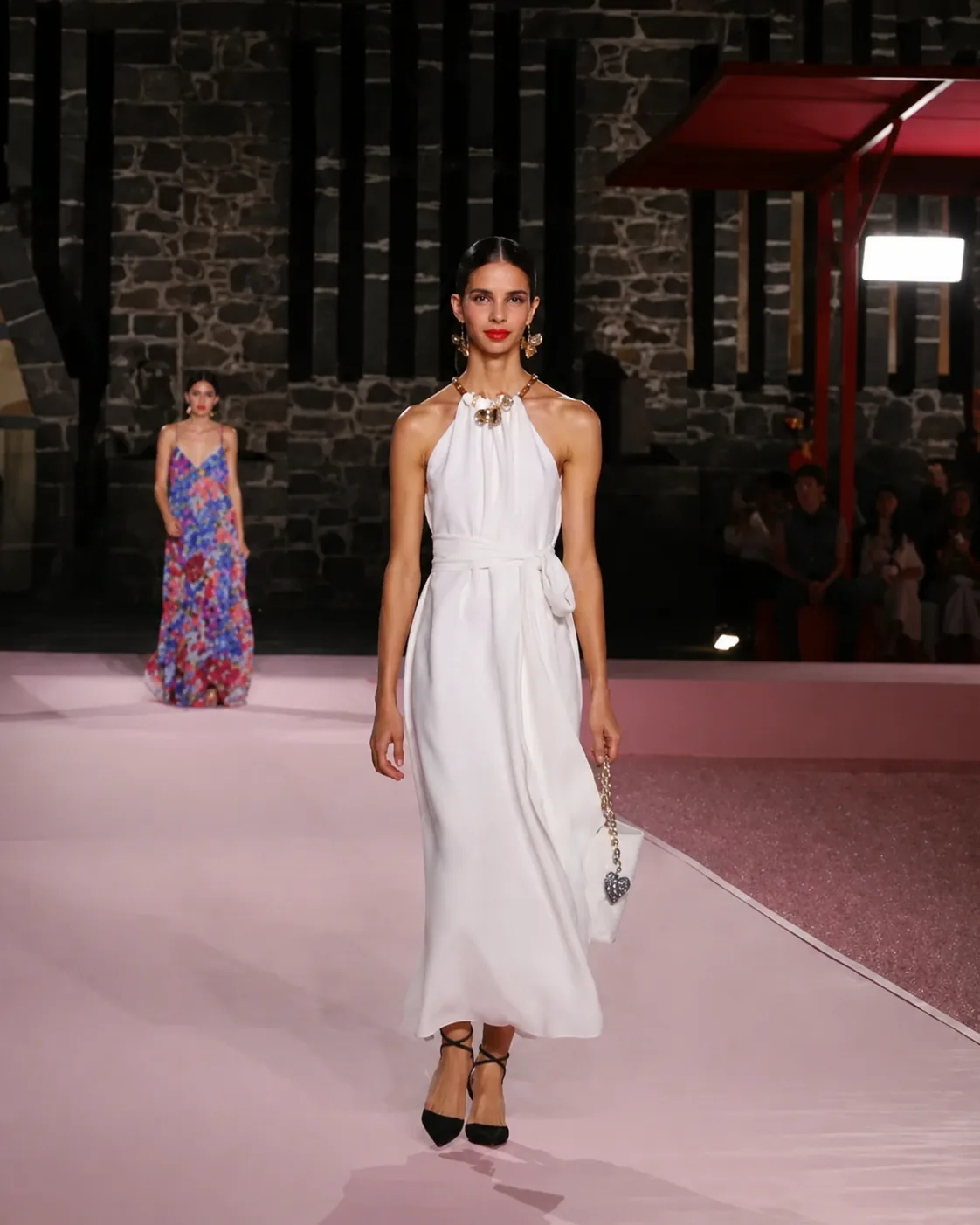 CAROLINA HERRERA — The collection on the pink, against the volcanic stone wall
