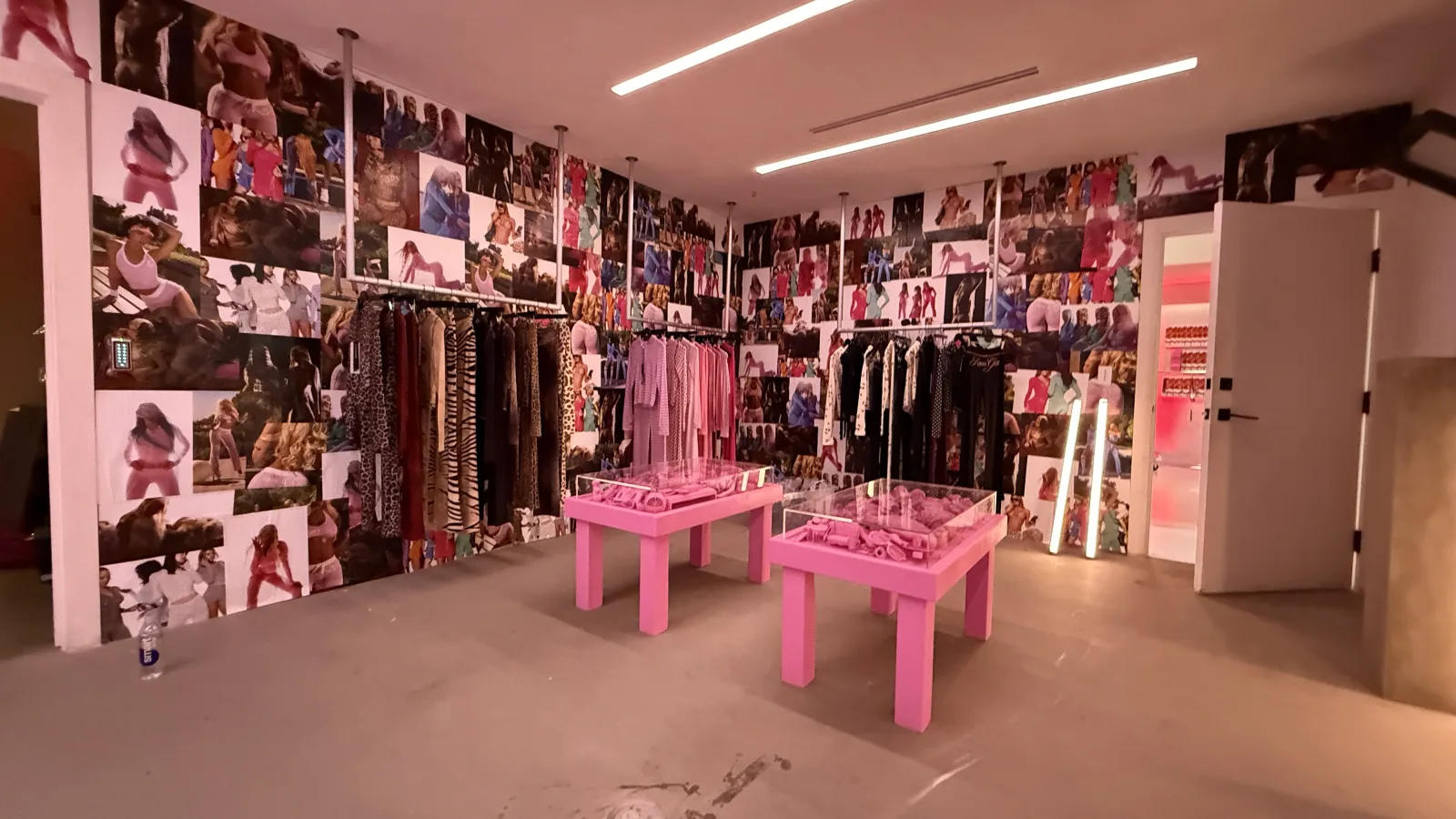I.AM.GIA — Inside the store: the campaign-papered walls and the pink tables