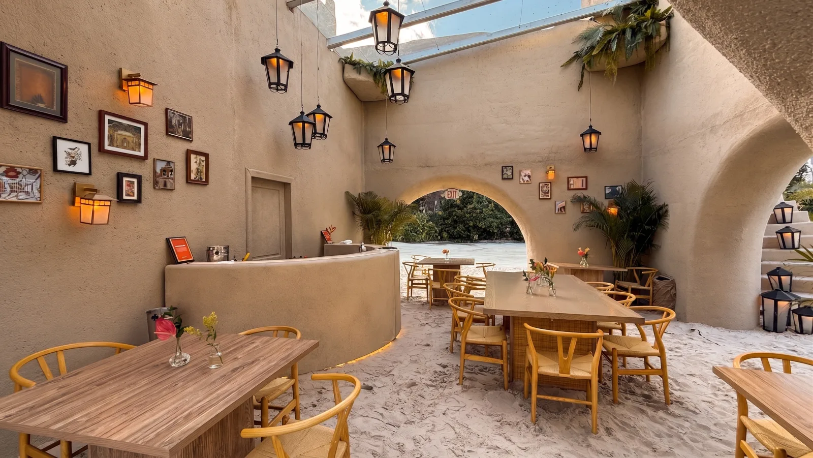 DOORDASH — The courtyard: wooden tables on the sand, under the lanterns
