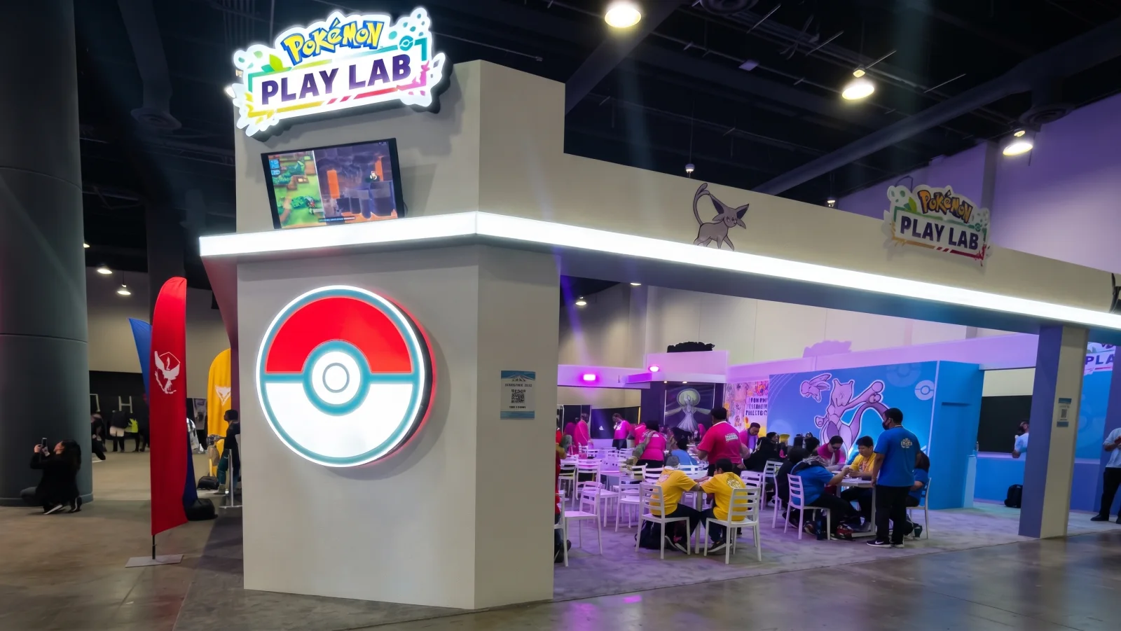 POKEMON PLAY LAB — The Play Lab corner: the lit Poké Ball and the sign, the tables behind