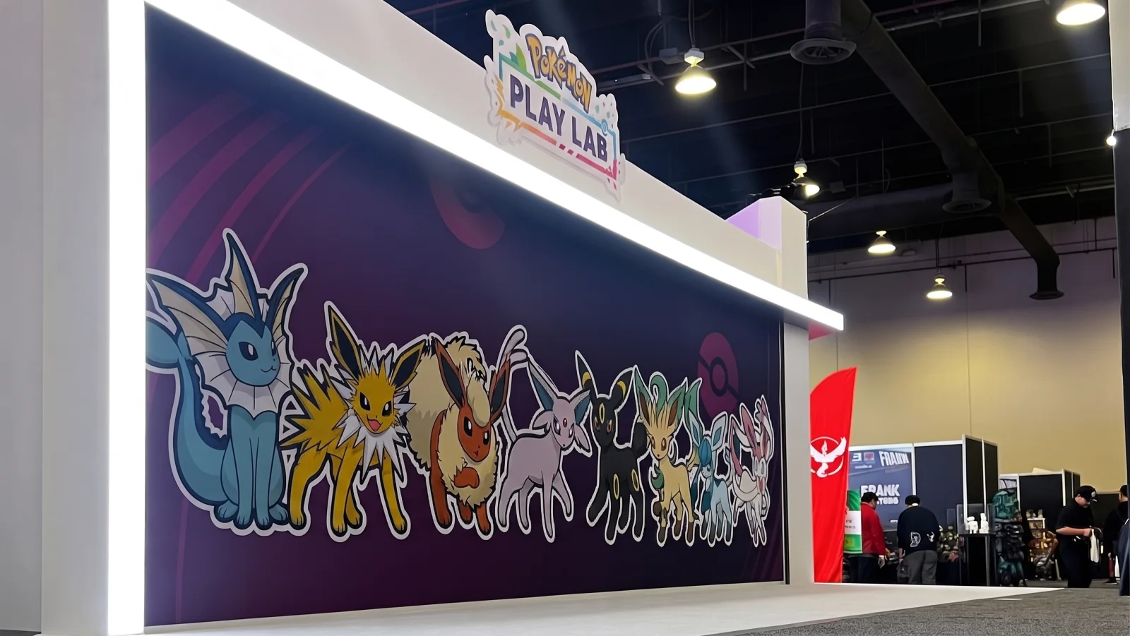 POKEMON PLAY LAB — The Eevee evolutions in a row on the purple wall, under the sign
