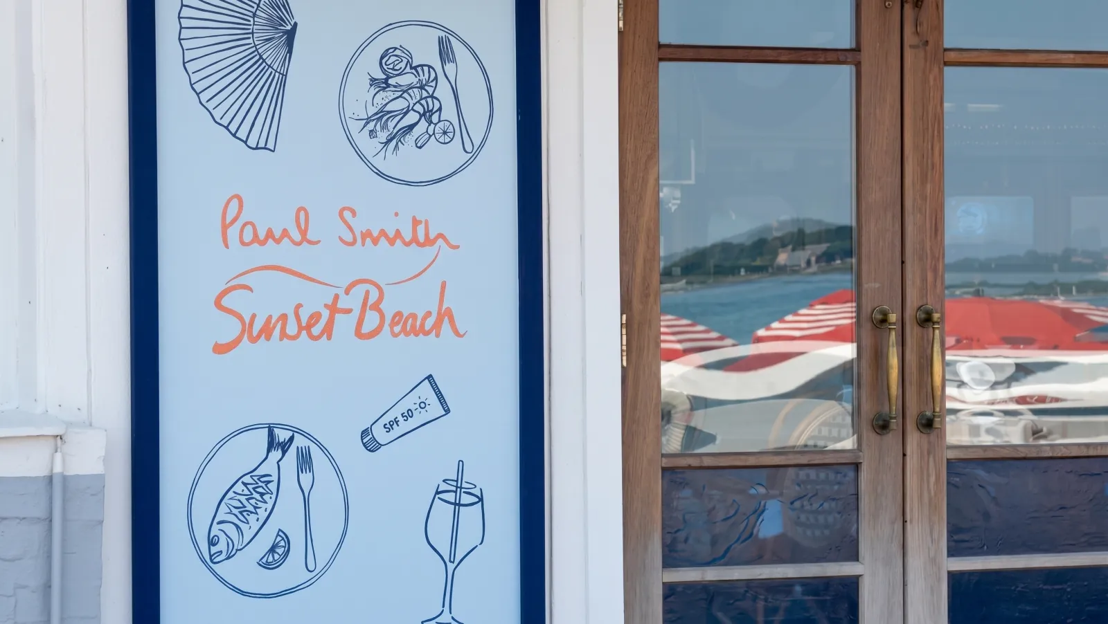 PAUL SMITH — The shop door: the drawings and the signature on the glass